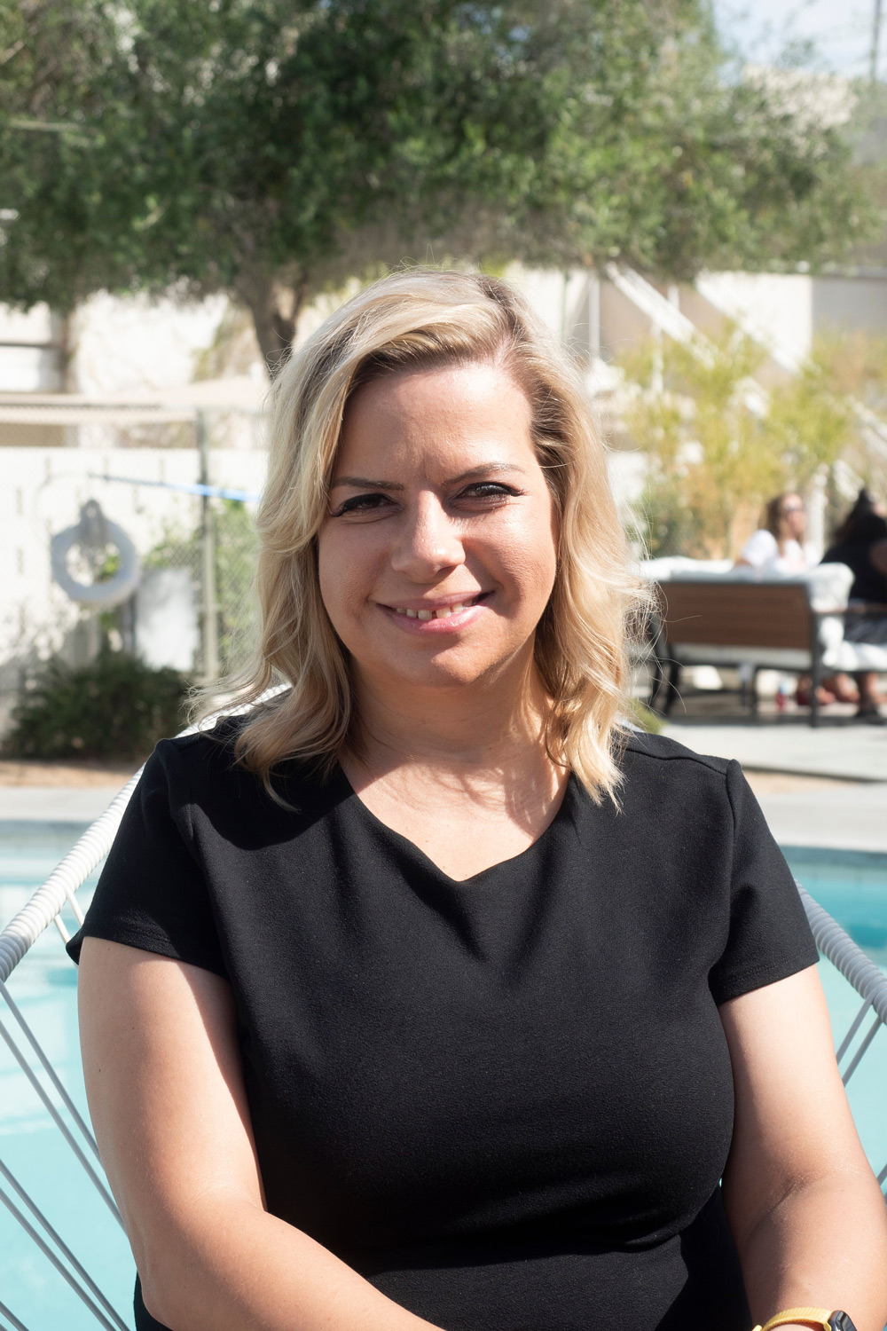 Lisa Burford sitting near a pool