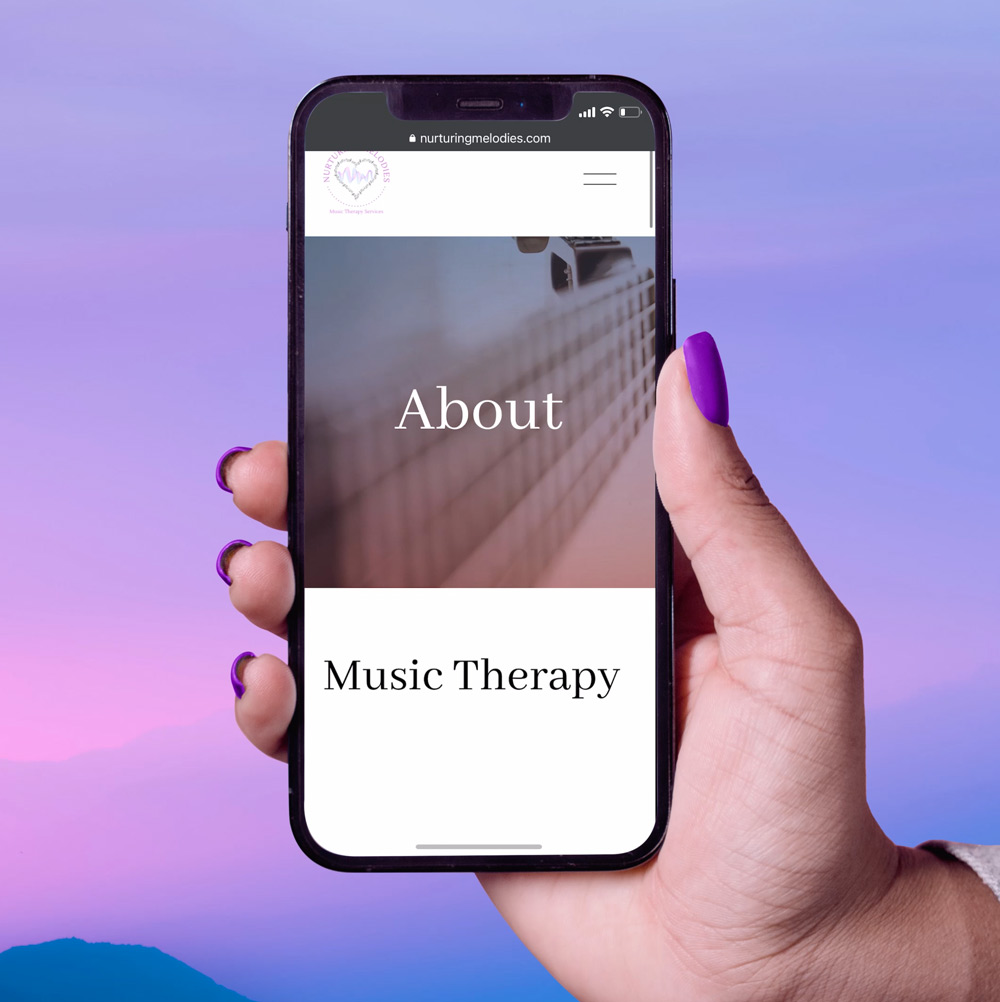 A hand with purple nail polish holds an iPhone up in the air with Nurturing Melodies website on the screen. The background is a pink, blue, and purple gradient sky.