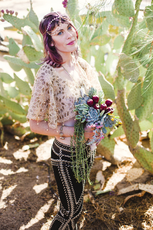 Beautiful bride holding a succulent bouquet with prickly pear cacti fruits